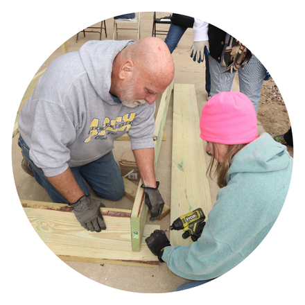 Two people building a garden box