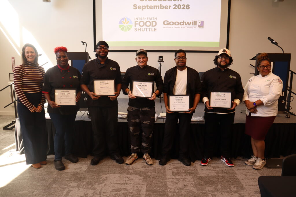 A group of 5 people holding certificates along with 2 additional people on the ends.